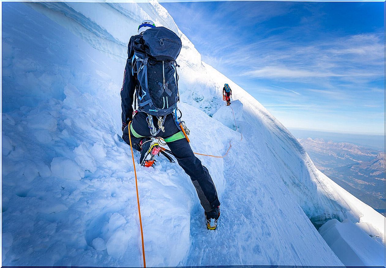 Tourists climbing on the ice in Iceland in winter.