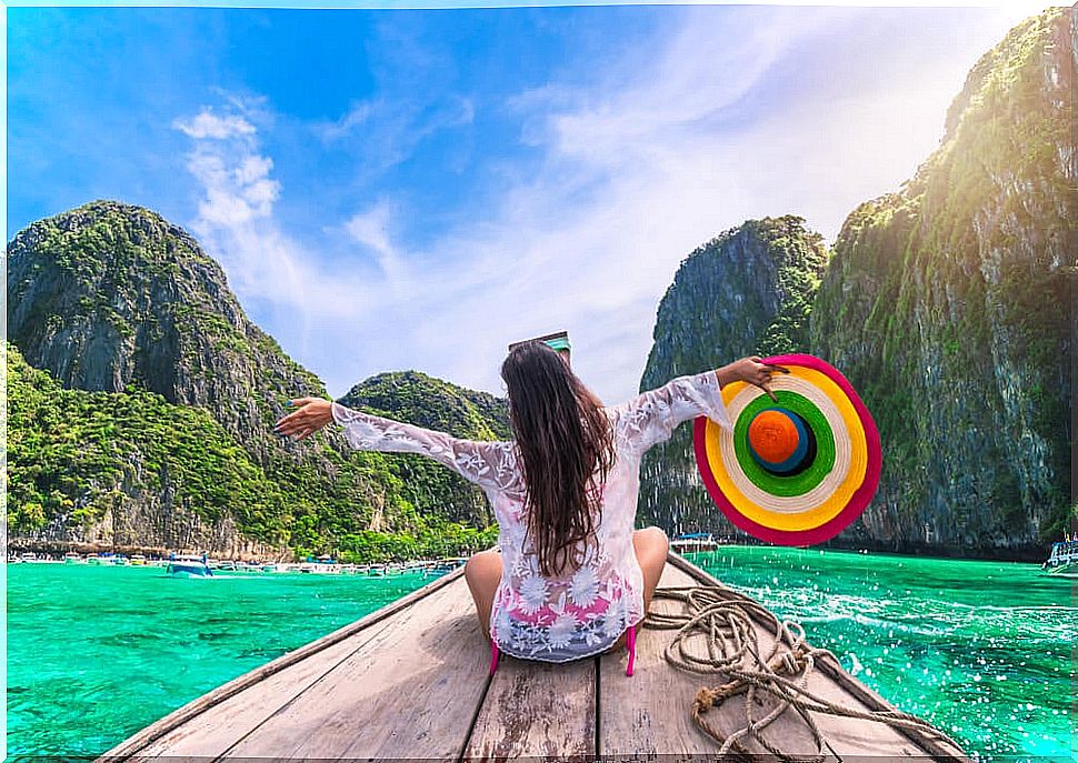 Happy female traveler demonstrating the psychological benefits of traveling