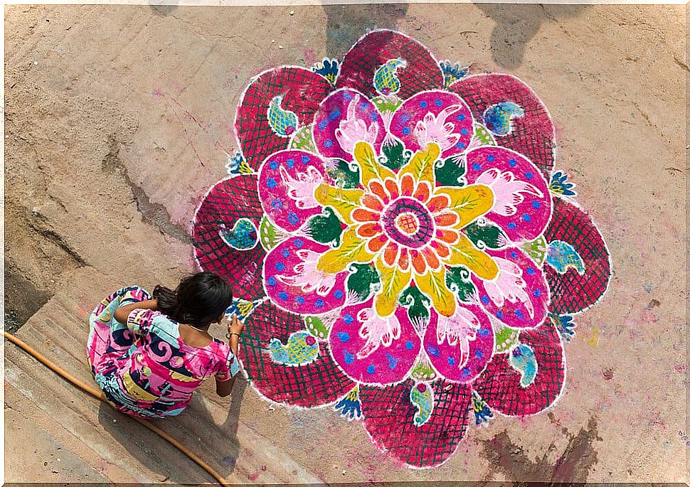 Woman painting a mandala, sample of Hindu art