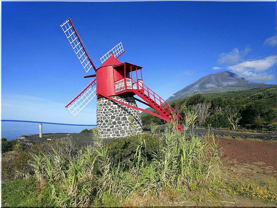 Mill and volcano on the island of Pico, in the Azores Islands.