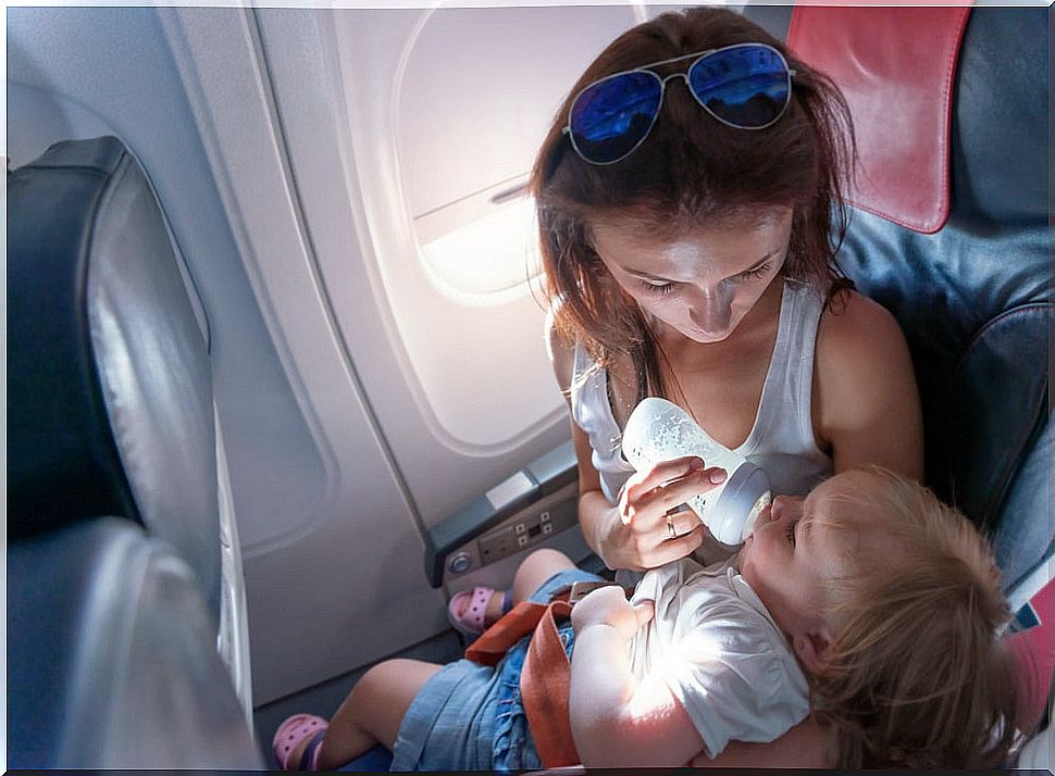 Mother feeding her son on the plane